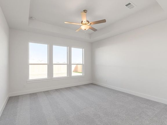 Primary bedroom with vaulted ceilings