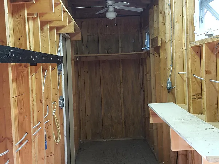 Workshop and storage area. Each end has very large storage areas for larger items. 2 ceiling fans to keep things cool.