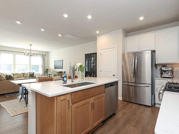 Open concept kitchen with quartz countertops and stainless steel appliances