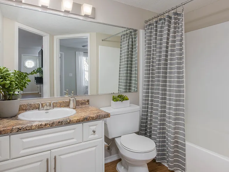 Sleek, updated bathrooms with ample counters and spacious mirrors embody a realm of elegance.