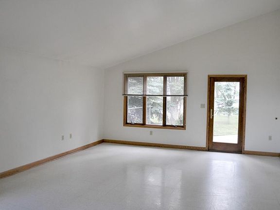 Spacious living room with access to the fenced in backyard.