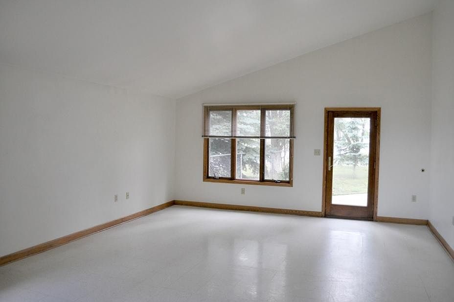 Spacious living room with access to the fenced in backyard.