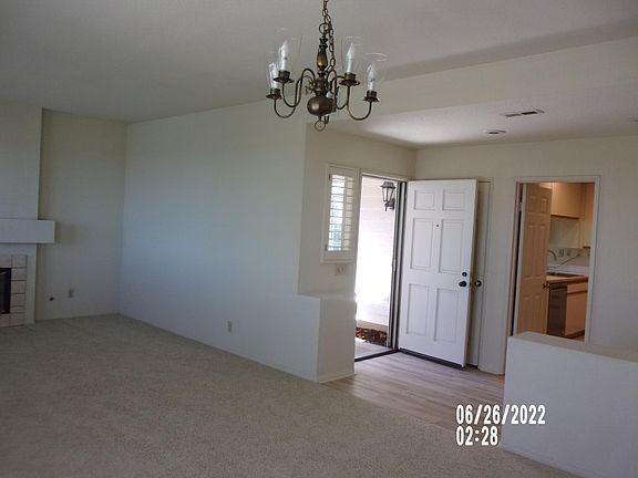 view from dining room to entry and door to kitchen