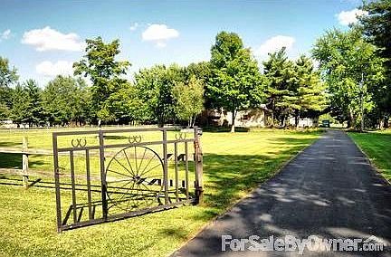 Wagon Wheel Gated Entry
						:
						Front is accented with board fencing w/electric inside. Custom designed gates.