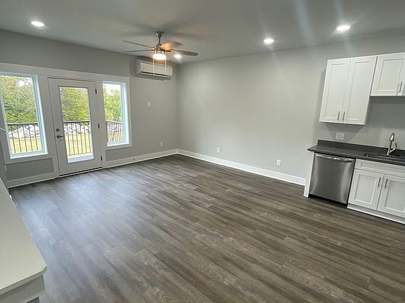 Living room and kitchen on second floor. Door exits to balcony.