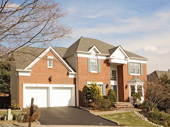 Brick front home has 2-car garage and lovely, private lot with back yard swimming pool!