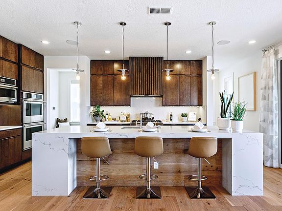 Chef s kitchen features double-height cabinets with under cabinet lighting