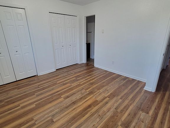 Second bedroom - door to on-suite bathroom is open.