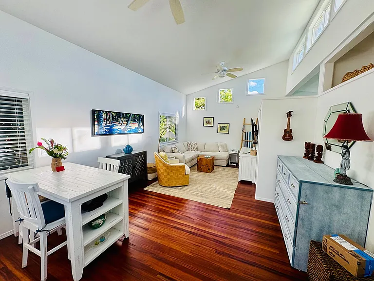 The cape-cod blue cabinet opens up to a very comfortable queen size bed. That's a professional ukulele (with digital tuner) hanging on the wall for you to use.