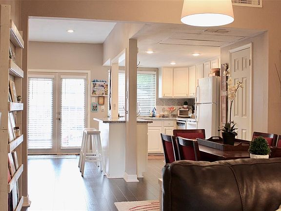 View of back french doors, renovated kitchen and breakfast/dining area