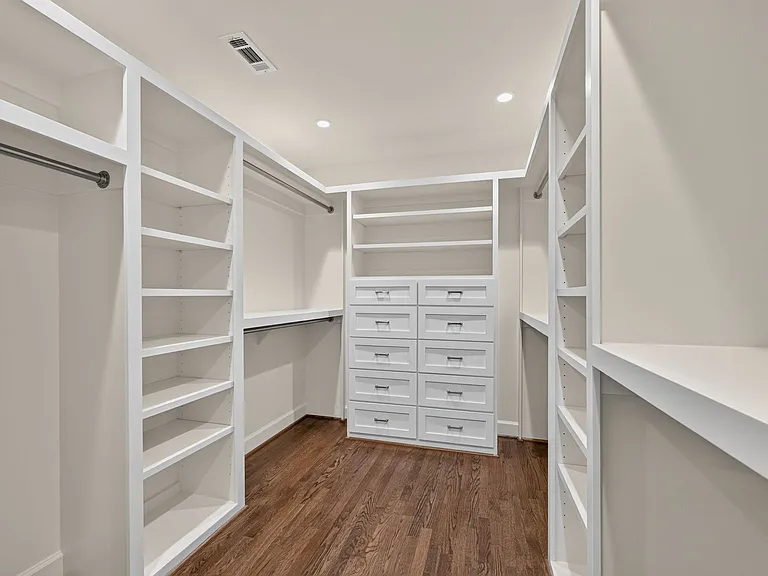 Large professionally designed closet with ample storage for two people.