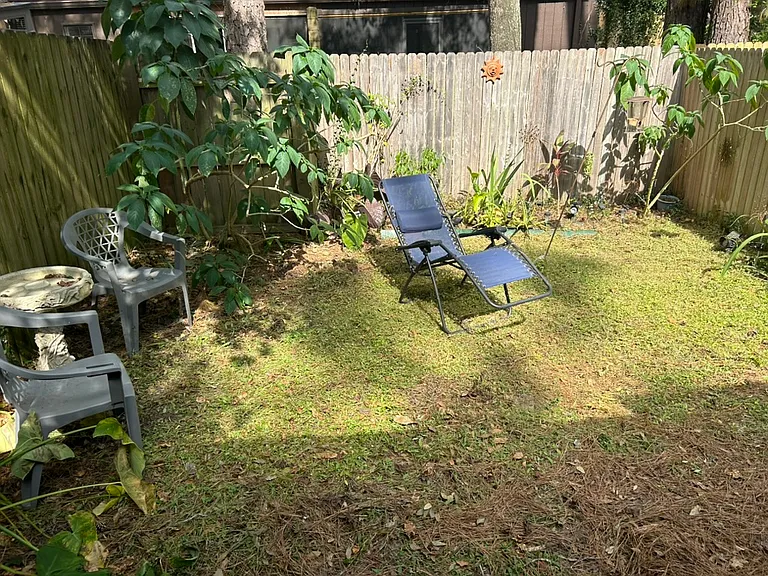 Fenced backyard with seating and lighting