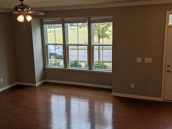 Living room with hardwood floor and ceiling fan.