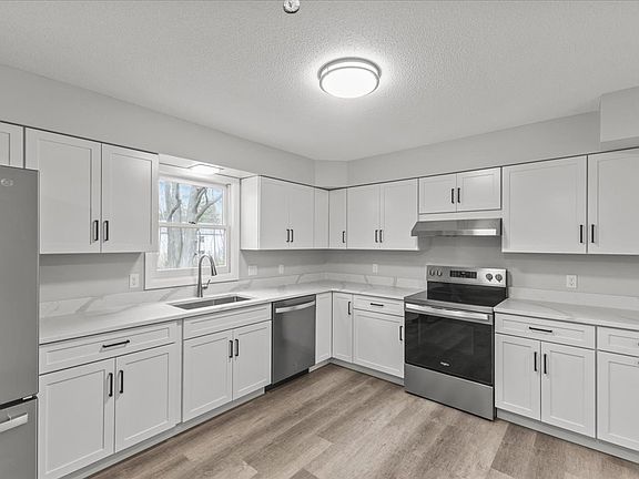 Kitchen with brand new counters, appliances, cabinets and flooring