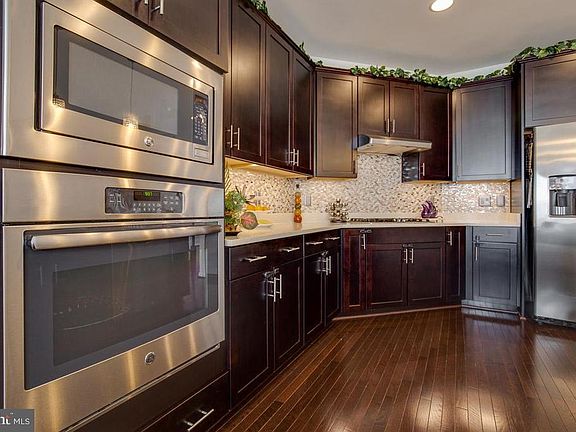 Kitchen features stainless steel appliances.