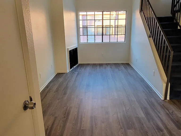 Living Rm, Gas Fireplace, Window View and Stairs to Bedrooms/Bathrooms