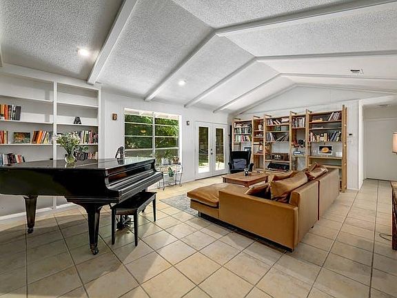 Living area... piano and shelving units stay