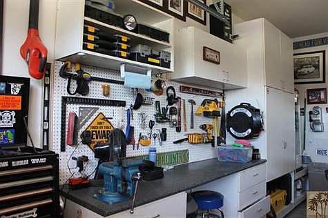 Garage with plenty of built-in cabinets.