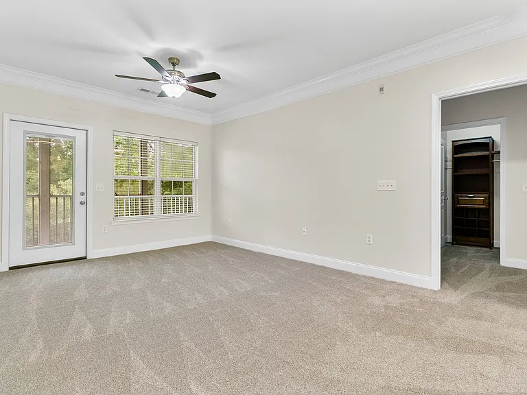 Living room and entry door to primary bedroom