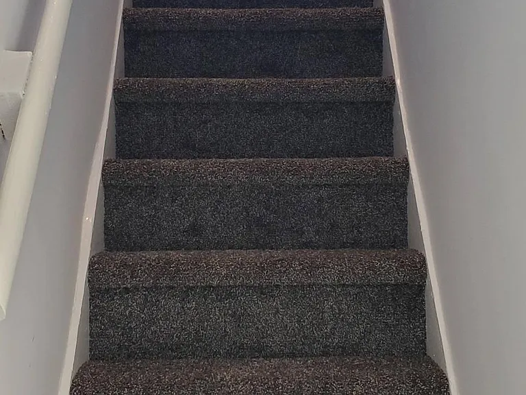 Newly carpeted steps to the 3rd floor.