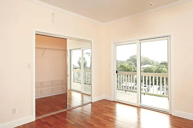 Primary bedroom doors to lanai and walk-in closet