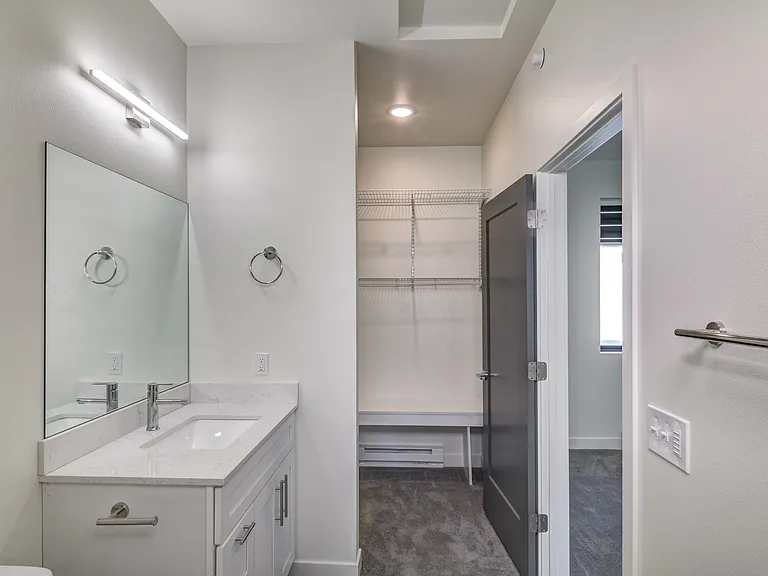 Full bathroom next to walk-in closet for one bedroom units