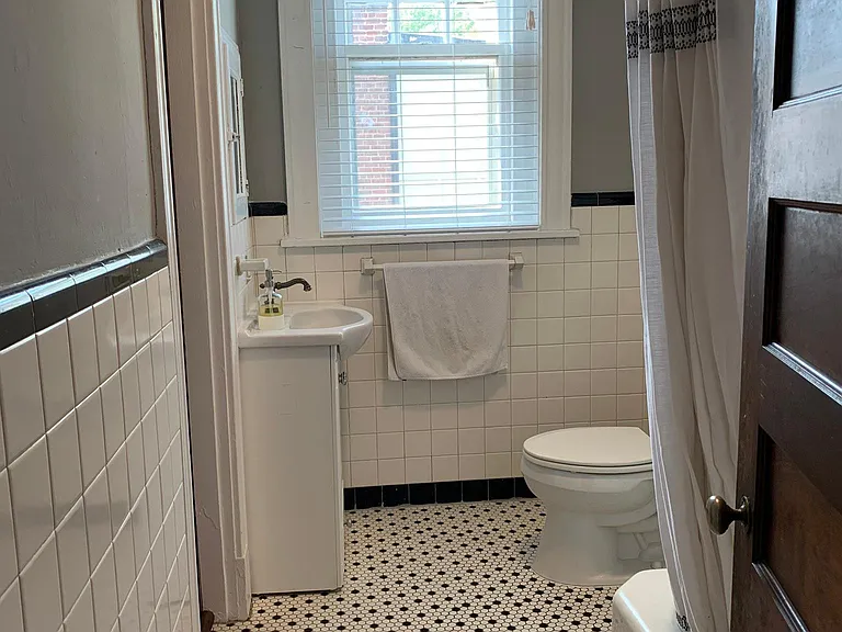 Full bath with tub servicing bedrooms 2 and 3 and common living space