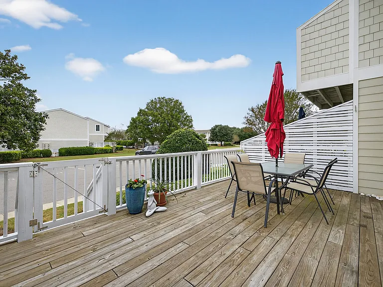 Expansive back deck with grill and table for 6. Across from the pool and clubhouse.