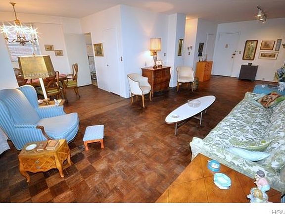 Large Sunny living room opens to the Dining Room.  There is a door leading to the balcony overlooking Garth Park and Playground.  The room has parquet floors, a large walk-in closet and is 30'-2" x 12'-4".