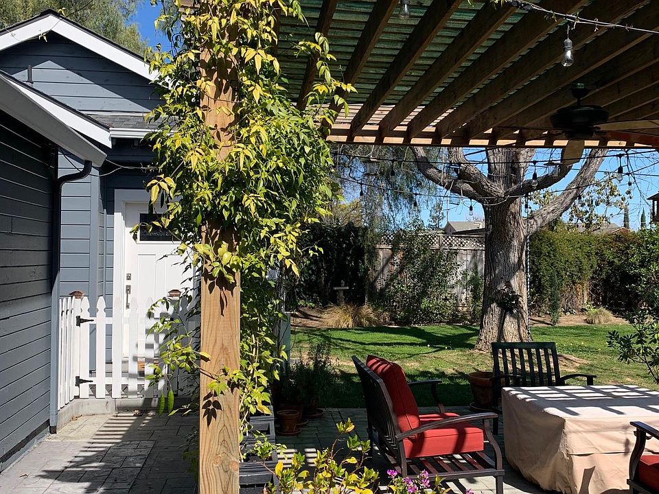 Sunny, front porch with a white picket gate.