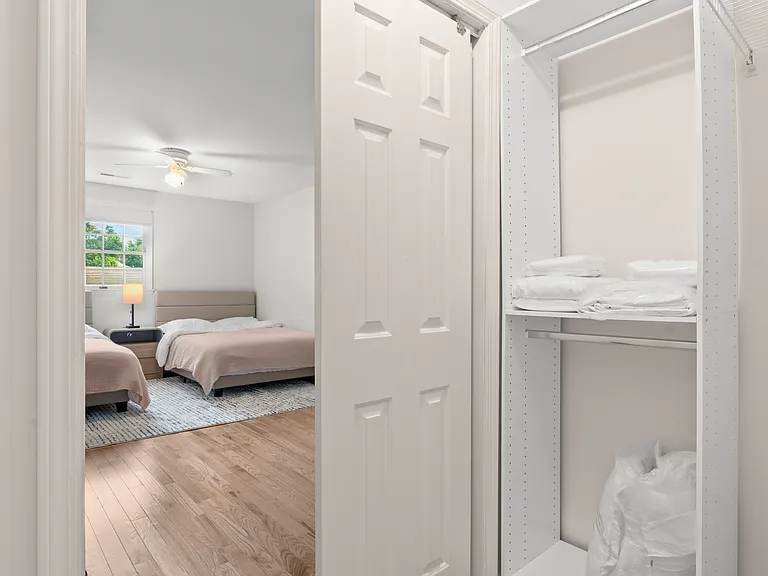 Upper-level bedroom with two full beds, two writing desks, and generous closet space.
