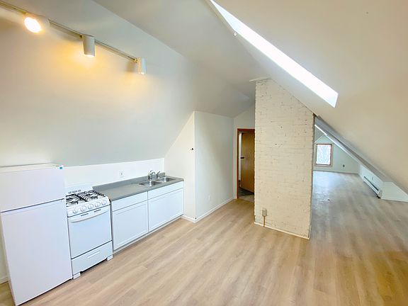 Unit 3 Kitchen with sleep and living areas beyond. Note multiple skylights. See the stars at night. View of victorian house from the sleeping and study area windows.