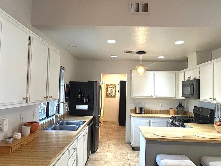 Recessed lighting on dimmer switch with globe pendant light.