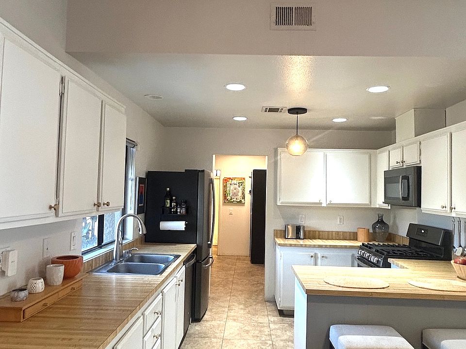 Recessed lighting on dimmer switch with globe pendant light.