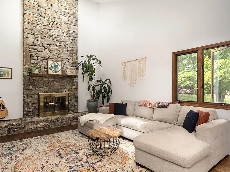 Bright and airy great room w/ mountain views, soaring ceilings & stone gas fireplace.