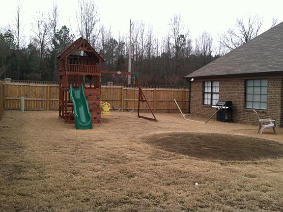 Fenced yard with gates on both sides of the house