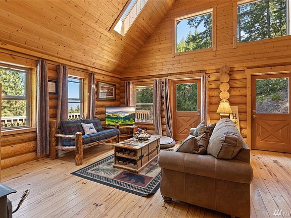 Dual access to the side/front deck. Large living space, all opened up to the dining & kitchen areas. So many windows - it feels like you are floating in the trees!
