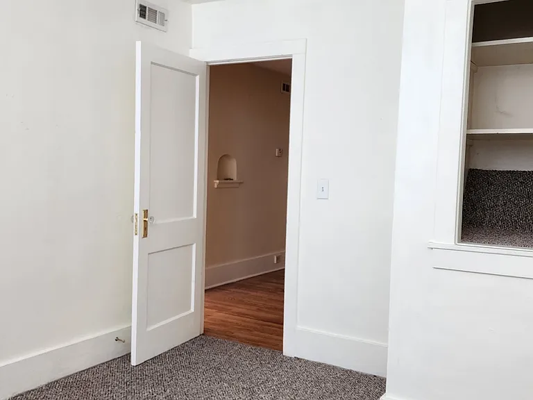 Front bedroom looking to the dining room showing storage