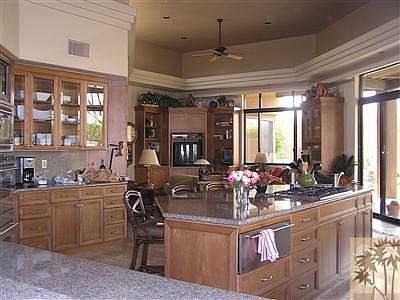 Gourmet kitchen with island has all the amenities expected and more...including a locked wine closet and attached family room. Kitchen is open to living area and flows well for entertaining. And there are wonderful mountain views and total privacy.