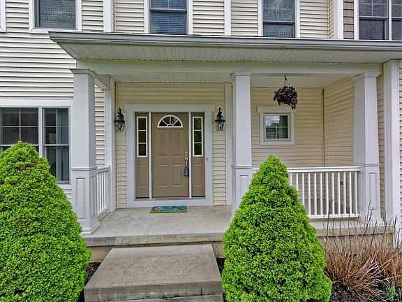 The covered front porch draws you in to this beautiful 10 year old, single owner, Amedore Colonial.