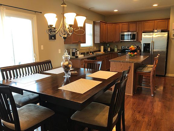 Open kitchen/dining area with sliding doors leading to back deck.