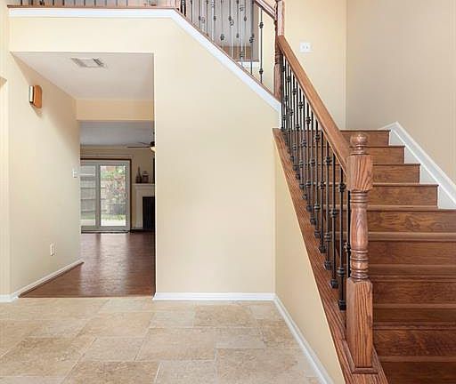 Recently updated iron spindles on the stairs and updated tile in the entry way.