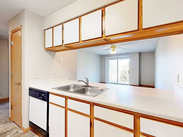 Pass-through kitchens keep cooking and conversation connected while offering generous counter space for everyday meals.