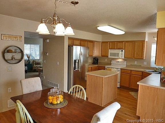 Dining Kitchen Combo w/Updated Lighting Throughout Home.