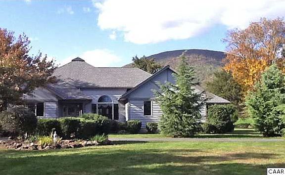 Front elevation of home- beautiful, mature and easy to maintain landscape