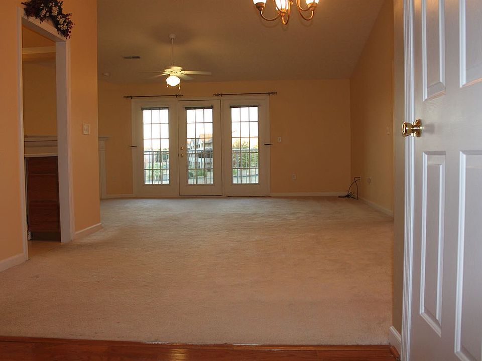 View of dining room and living room, with spacious cathedral ceilings