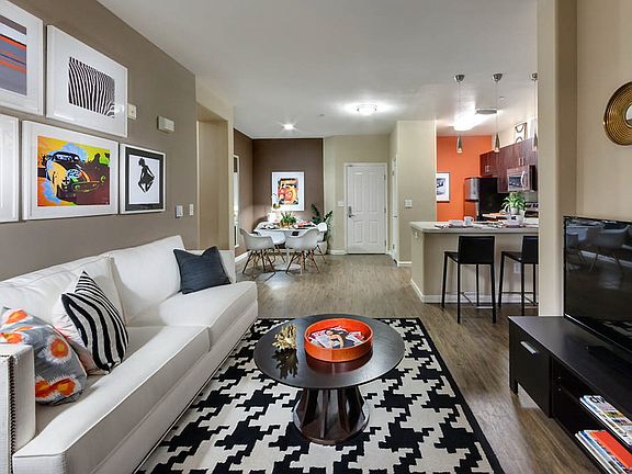 Staged living room with hardwood-style vinyl flooring.