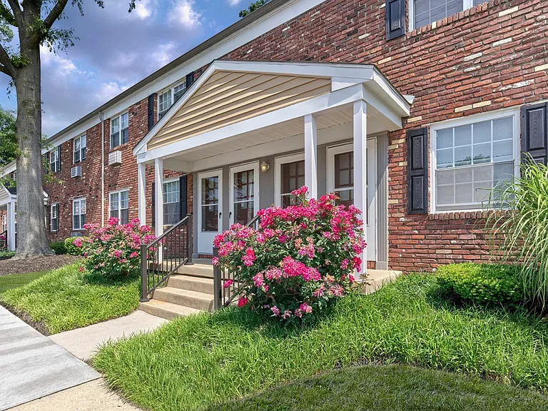 Beautiful red brick exterior and vibrant landscaping at Maple Terrace Apartments in Maple Shade, NJ