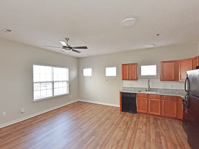 Kitchen and dining area with hardwood-style flooring