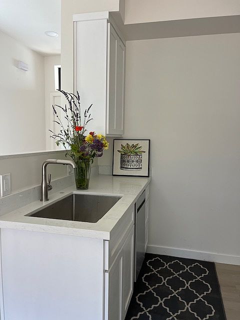 Entry opens into the kitchen, living room, dining areas with ample natural light through the entry windows, sliding glass door to the private patio.